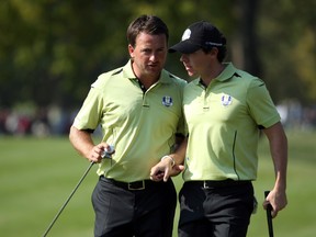 Graeme McDowell (left) and Rory McIlroy discuss strategy yesterday at Medinah Country Club. (GETTY IMAGES)