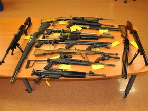 Photo courtesy OPP
OPP officials released this photograph showing some of the guns seized at a home in Stone Mills Township during a raid early Friday morning. Two local men face a number of charges.