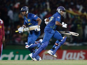 Sri Lanka's captain Mahela Jayawardene (right) and his teammate Kumar Sangakkara run between the wickets during their Twenty20 World Cup Super 8 cricket match against West Indies in Pallekele on Saturday. (REUTERS/Dinuka Liyanawatte)