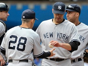 New York Yankees pitcher Andy Pettitte is pulled by manager Joe Girardi (L) during the sixth inning of their MLB American League baseball game against the Toronto Blue Jays in Toronto September 29, 2012. (MIKE CASSESE/Reuters)