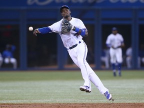 Blue Jays infielder Adeiny Hechavarria turns a double play in the fourth inning against the Minnesota Twins at the Rogers Centre on Tuesday night. (Getty Images/AFP)