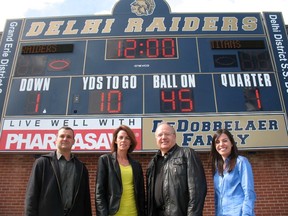 A new digital scoreboard was recently installed at Delhi District Secondary School just in time for this week’s Friday Night Lights game against Holy Trinity Catholic High School. The scoreboard was made possible thanks to donations by the DeDobbelaer family, Delhi Pharmasave, the DDSS Booster Club and the Grand Erie District School Board. Representing the scoreboard sponsors are, from left: Darren DeDobbelaer, Alison High (Grand Erie), John Stancyzk (Delhi Pharmasave) and Lindsay Robyn (Booster Club). (SARAH DOKTOR Delhi News-Record)