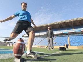 Rich Pope gets some kicking advice from Bombers kicker Justin Palady. Pope was selected as one of four finalists in the Wendy's Kick for a Million contest. (Chris Procaylo/Winnipeg Sun)