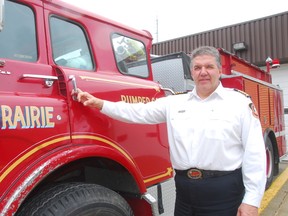 The Portage la Prairie fire chief Phil Carpenter stands next to the department's 1984 pumper. (File photo)