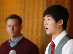 Olympic speedskater Simon Cho (R) speaks during a press conference as his attorney John Wunderlin looks on in Salt Lake City, Utah October 5, 2012.  Cho admitted to tampering with a rival's skate when asked by U.S. short tack speed skating coach Jae Sun Chun to bend the skate of Canadian Olivier Jean's at the 2011 World Championships. (REUTERS)