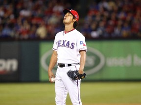 Texas Rangers pitcher Yu Darvish takes a deep breath in the seventh inning of their MLB American League Wild Card playoff baseball game against the Baltimore Orioles in Arlington, Texas Oct. 5, 2012. (Tim Sharp/Reuters)