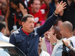 Venezuelan president Hugo Chavez waves to supporters after casting his vote during Presidential elections in Caracas October 7, 2012.  (REUTERS/Jorge Silva)
