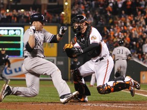 New York Yankees' Russell Martin (L) is tagged out trying to score at home by Baltimore Orioles' catcher Matt Wieters in the seventh inning during Game 1 in their MLB ALDS playoff baseball series in Baltimore, Maryland October 7, 2012. (REUTERS)