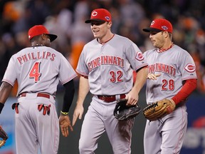 Cincinnati Reds right fielder Jay Bruce (32) celebrates with teammates Brandon Phillips and  Chris Heisey after defeating the San Francisco Giants follwing Game 2 of their MLB NLDS playoff baseball series in San Francisco, California October 7, 2012. (REUTERS)