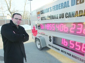 Colin Craig, prairies director of the Canadian Taxpayer Federation with the debt clock.  (File photo)