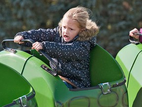 Five-year-old Tiana Austin of Burford doesn't seem to be enjoying her ride on a children's roller coaster as much as her nine-year-old sister Noelle on Monday, October 8, 2012 at the Burford Fair.
BRIAN THOMPSON/BRANTFORD EXPOSITOR