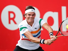 Milos Raonic of Canada returns a shot against Andy Murray of Britain at the men's singles semifinals match at the Japan Open tennis championships in Tokyo, October 6, 2012. (REUTERS)
