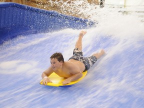 Gibson Osetsky, 10, spends his rainy Tuesday afternoon getting soaked as he takes a ride on the WaveRunner at the Eastlink Centre on Aug. 14, 2012. The centre has seen more than half a million visitors since opening nine months ago. GRAEME BRUCE/DAILY HERALD-TRIBUNE