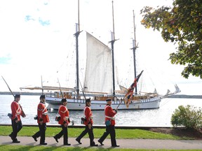 Members of the Brockville Infantry Company re-enactors' group march past the arriving tall ship Empire Sandy at Centeen Park last year.