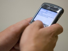 Photo of a man texting. (QMI Agency/MIKE HENSEN)