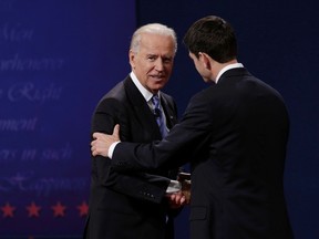 U.S. Vice President Joe Biden (L) and Republican vice presidential nominee Paul Ryan (R) shake hands at the conclusion of the vice presidential debate in Danville, Kentucky Oct. 11, 2012.    REUTERS/John Gress