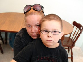 Riley Thorpe, 8, with mother Krystal, holds out his broken writst on Monday, Oct. 15, 2012. Riley broke his arm in his school in Brampton and had to wait three hours for his mother to pick him up to take him for medical attention. (JENNY YUEN/Toronto Sun)