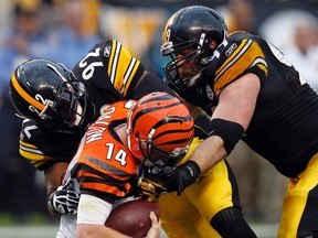 Pittsburgh Steelers James Harrison and Brett Keisel sack Cincinnati Bengals quarterback Andy Dalton in the third quarter of their NFL football game in Pittsburgh, Pennsylvania, December 4, 2011. (REUTERS/Jason Cohn)