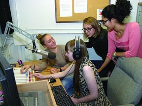 CFRC radio staff (l-r) Dorothea Paas, Joanna Plucinska, Savita Rani and Lisa Aalders (at the microphone) discuss the Queen’s University radio station’s programming.