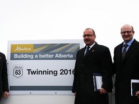 Fort McMurray MLAs Mike Allen, left, and Don Scott, right, join transportation minister Ric McIver for the unveiling of a newly-twinned 36-kilometre stretch of Highway 63 outside Wandering River. McIver announced that the province will twin the highway by the fall of 2016. VINCENT MCDERMOTT/TODAY STAFF