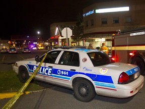 Ottawa Police investigate a double shooting at the Gloucester Centre on October 26, 2011. Graham Thomas, 35, and Jason Chapman, 31, were gunned down outside Thomas' tanning salon. (ERROL McGIHON/OTTAWA SUN)