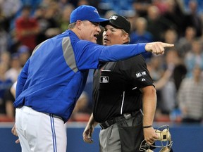 John Farrell argues a call with home plate umpire Marvin Hudson during the Blue Jays’ final homestand early this month against the Minnesota Twins. (REUTERS)