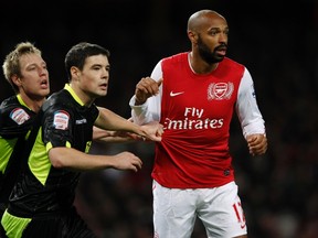 Arsenal's Thierry Henry (right) is marked by Leeds United's Luciano Becchio (left) and Darren O'Dea during their FA Cup match in London last January. (Eddie Keogh/Reuters/Files)