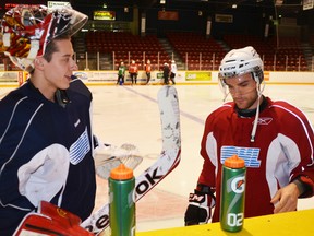 Jordan Binnington, left, and Daniel Catenacci during a break in the Owen Sound Attack’s practice Tuesday at the Harry Lumley Bayshore Community Centre.