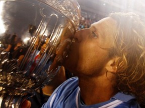 Uruguay's Diego Forlan kisses the Copa America trophy after beating Paraguay in the final soccer match in Buenos Aires, July 24, 2011. (REUTERS)