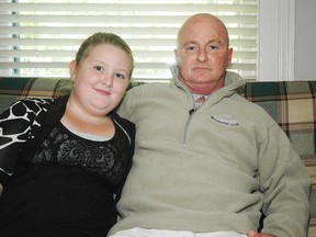 Ed McDade and his 11-year-old daughter, Faith, at their St. Thomas home. McDade is currently fighting for access to the drug Avastin to prolong his life.