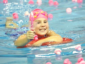 Mackenzie Noble, 9, participates in the Sudbury Synchro Swim Club annual Burning Bright for Breast Cancer fundraiser at the pool at Laurentian University in Sudbury on Thursday, October 25, 2012. More than 50 synchro swimmers helped to raise more than $10,000 for the event. JOHN LAPPA/THE SUDBURY STAR/QMI AGENCY