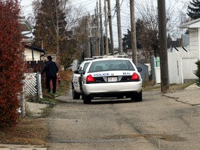 Police takes down police tape in a alley near 132 ave and 72 st in Edmonton, Alberta on October 24, 2012.  A human head was found in the alley and police forensic were on scene early this morning. (PERRY MAH/QMI AGENCY)