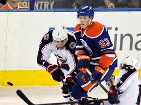 Oilers forward Ryan Nugent-Hopkins tangles with Blue Jackets defenceman Jack Johnson at Rexall Place in Edmonton, Alta., March 14, 2012. (DAN RIEDLHUBER/Reuters)