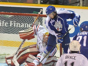 Owen Sound Attacks goalie Jordan Binnington gropes for the puck with his glove while battling Sudbury Wolves Josh Leivo in his crease during first period OHL major junior hockey action on Saturday October 27, 2012 at the Lumley Bayshore in Owen Sound. --The Sun Times\JAMES MASTERS\QMI Agency.