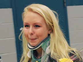 Erika Crawford reacts to cheers at an assembly held at St. John's College on Thursday to welcome her back to the school after successful surgery for Ehlers-Danlos syndrome. The surgery shaved part of her skull and some vertabrae, realigned her spine and skull and used one of her ribs to stabilize her neck. Prior to the surgery Erika was in constant danger of collapse and any fall or sudden movement could have either killed her or made her a quadriplegic. - CHRISTOPHER SMITH, The Expositor