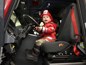 Two-year-old Jack Connors sits in the driver seat of a fire truck during the grand opening of the award winning Ellerslie Fire Station in Edmonton, Alberta on Saturday Nov. 3, 2012.  PERRY MAH/EDMONTON SUN /QMI AGENCY