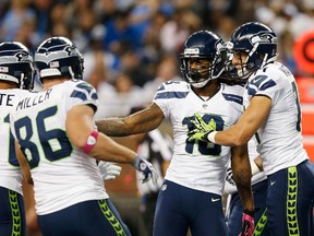 Sidney Rice, 18, of the Seattle Seahawks celebrates a nine-yard touchdown pass from Russell Wilson and is congratulated by teammate Charly Martin during the second quarter at Ford Field on Oct. 28 in Detroit.  Leon Halip/Getty Images/AFP