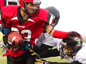 Brandon Thiessen and the Leduc Tigers ran their way past the Holy Trinity Trojans during the Miles Conference high school football championships at Foote Field on Saturday, Nov. 3, 2012