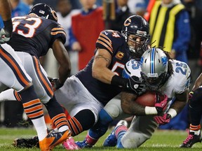 Chicago Bears middle linebacker Brian Urlacher (54) tackles Detroit Lions running back Mikel Leshoure (25) during the first half of their NFL football game at Soldier Field in Chicago, October 22, 2012. REUTERS/Jeff Haynes