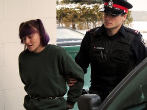 Aleisha Block, accused of second degree murder, is led by police to the Superior Court of Justice in Timmins in November 2012.