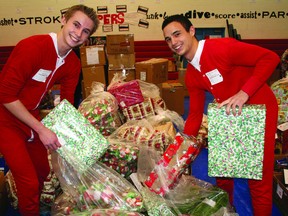 Father Merc students do some gift-packing during the Santas Anonymous delivery day. TODAY FILE PHOTO