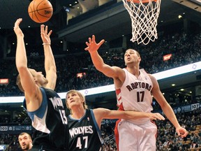 Minnesota Timberwolves guard Luke Ridnour (left) grabs a rebound in front of Andrei Kirilenko and Raptors’ Jonas Valanciunas during their game on Sunday. The Raptors rookie had four points and four rebounds. (REUTERS)