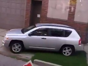 Video screengrab shows a person driving a car on the sidewalk to get around a school bus. (YOUTUBE)