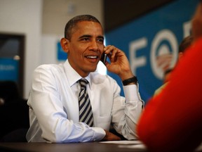 U.S. President Barack Obama makes a phone call to a volunteer as he visits a campaign field office in Chicago, on election day November 6, 2012. (REUTERS/Jason Reed)
