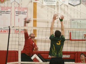 Jacob Boutwell of the Senior Boys St. Thomas Aquinas Saints spikes a nail down on the Queen Elizabeth District High School Warriors. The Saints beat the Sioux Lookout team in three sets for the NorWOSSA title. 
JON THOMPSON/Daily Miner and News