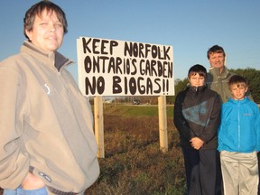 Motorists know they are getting close to the former Bick’s Pickle tank farm northeast of Delhi when they encounter signs opposing a proposed biogas generating facility at the site. Among the neighbours fighting the project are the Kauk family of the Windham West Quarter Line Road near Vanessa. At left is Rachelle Kauk while are right is Chris Kauk with their sons Matthew and Nicholas. (MONTE SONNENBERG Simcoe Reformer file photo)