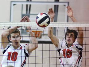 Dan Miller and Dave Carroll of the Walkerton Sacred Heart Crusaders block a shot during a BAA senior boys volleyball championship final against the OSCVI Falcons. Its not yet know what extracurricular activities will return to local schools
