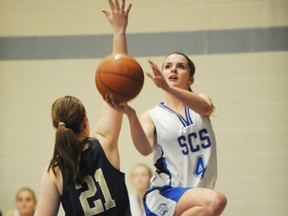 Simcoe’s Gillian Ponds takes a shot as Delhi’s Devin Cowbrough aims to block during the senior girls basketball NSSAA finals held at Simcoe Composite School on Nov. 8. (SARAH DOKTOR Simcoe Reformer)