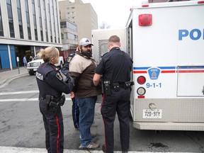Greater Sudbury Police arrested 12 people during a protest at Sudbury MPP Rick Bartolucci's office on Cedar Street in Sudbury on Friday, November 9, 2012. Among those who were removed from the scene were Laurentian University sociology professor and anti-poverty activist Gary Kinsman, and Sudbury Star reporter Carol Mulligan, who was covering the protest. JOHN LAPPA/THE SUDBURY STAR/QMI AGENCY
