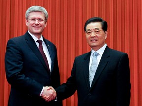 Chinese President Hu Jintao (R) shakes hands with Canadian Prime Minister Stephen Harper before their meeting at the Great Hall of the People in Beijing February 9, 2012. (REUTERS files/Diego Azubel/Pool)